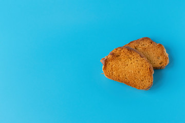 Crispy cracker on a blue background. Salty tea biscuits. Healthy Diet Snack..