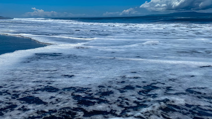 Naklejka na ściany i meble A desolate ocean shore with rolling waves. Background banner panorama