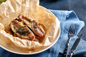 Fillet of white fish pollock, cod, sea bass, sea bream with olives, tomatoes and lemon, baked in...