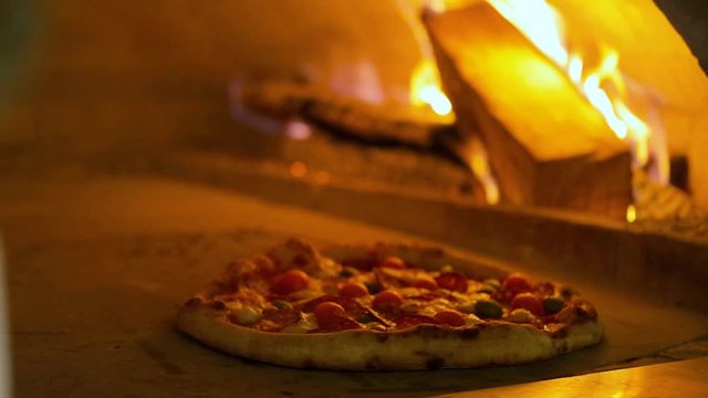 Italian pizza Pepperoni is cooked in the oven, restaurant pizza cooking in a wood fired oven at traditional restaurant.
