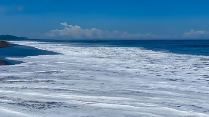 A desolate ocean shore with rolling waves. Background banner panorama