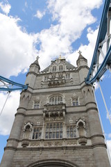Fototapeta na wymiar Top part of Tower Bridge with the blue sky and clouds on a bright sunny day in spring, London, UK