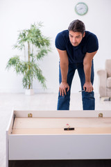 Fototapeta premium Young male contractor installing furniture at home