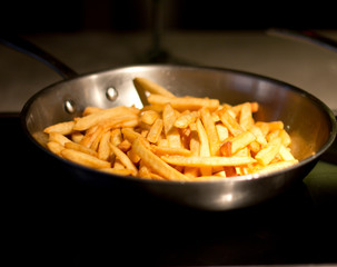 French fries in a black pan.