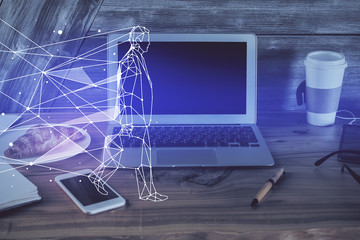 Desktop computer background in office and start up theme hologram drawing. Double exposure. Startup concept.
