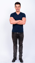 Fototapeta premium Full body shot of happy young handsome man smiling with arms crossed