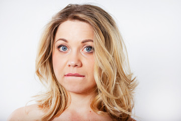 Isolated portrait of an upset woman. Sad female face. Young beautiful woman on a white background.