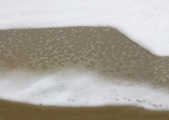 Foam merges with sand