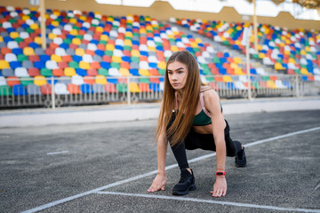 Woman in sportswear doing morning run on the stadium