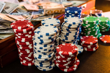game and entertainment concept - many different casino chips on play table surface.  close up.