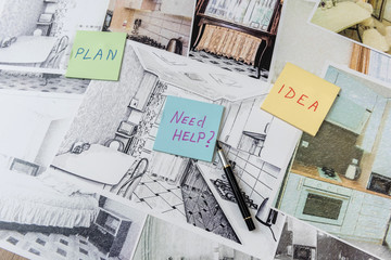 Drawings of a house or apartment are on the table. Designer desk with graphic outline of apartment. Architects project