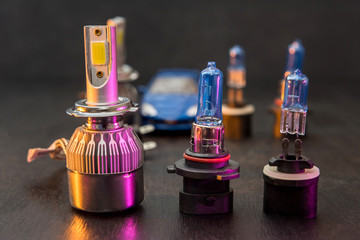 Different LED bulbs for car isolated on black wooden background. Modern car lighting technology.