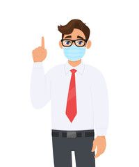 Young business man covering face with medical mask and pointing finger up symbol. Trendy person wearing facial hygienic surgical mask and gesturing hand sign. Cartoon design illustration in vector.