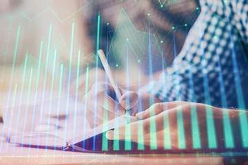 Multi exposure of two men planing investment with stock market forex chart.