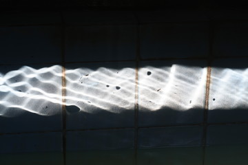 undulating highlight caused by pond water reflection
