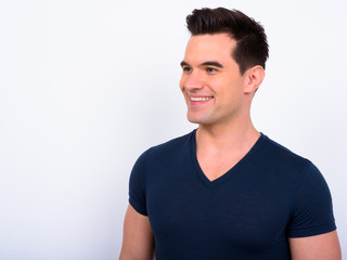 Face of happy young handsome man thinking