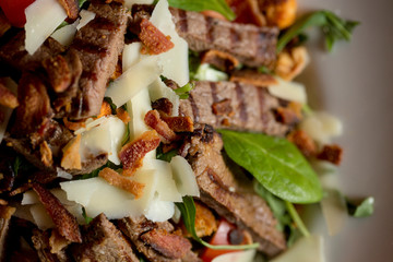 Beefsteak salad with lettuce, rocket,  and spinach with parmesan and .homemade spicy croutons