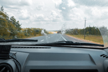 Cleaning the car's windshield with a windscreen wiper - obrazy, fototapety, plakaty
