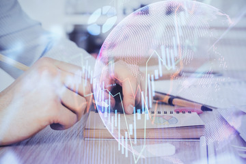 Multi exposure closeup hands with stock market forex graph.
