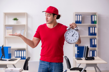 Young male courier delivering pizza to the office