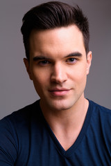 Fototapeta premium Face of young handsome man looking at camera