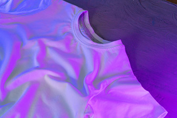 White color unisex t-shirt in neon light , copy space