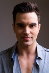 Face of young handsome businessman looking at camera