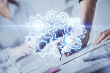 International business hologram over hands taking notes background. Concept of success. Multi exposure