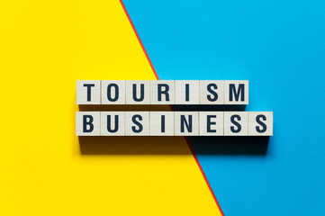 Tourism business word concept on cubes
