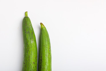 Fresh green sponge gourd or luffa on white background