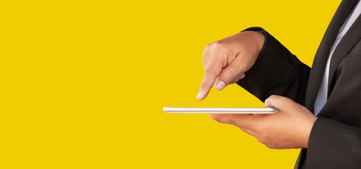 Business women use tablets to work on a yellow background