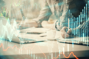 Multi exposure of forex chart with man working on computer on background. Concept of market analysis.