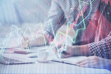 Multi exposure of forex chart with man working on computer on background. Concept of market analysis.