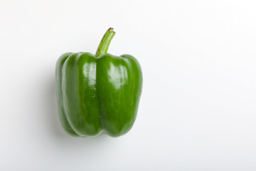 fresh green bell pepper (capsicum) on a white background
