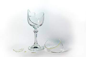 A broken goblet glass on a white background.