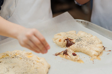 Young children make dough products. Hands closeup
