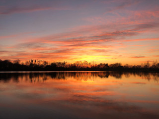 Fototapeta na wymiar Sunset reflection in a lake around Zelhem, The Netherlands