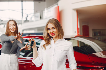 Women buying the car. Ladies in a car salon