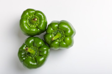 fresh green bell pepper (capsicum) on a white background