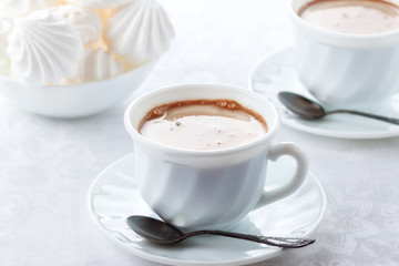 A cup of fresh coffee with cream and a gentle, airy Bizet