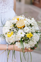 wedding bouquet in brides hands of bride