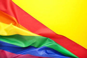 Rainbow LGBT flag on yellow background with copy space