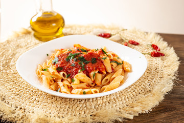 Penne pasta with tomato sauce. Traditional Italian dish, pasta with chili sauce. Italian food.