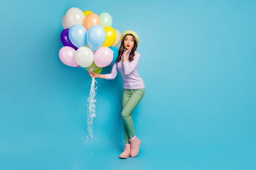 Fototapeta na wymiar Wow. Full length photo of pretty lady hold colorful air balloons friends surprise event party wear purple pullover beret cap green pants footwear isolated blue color background