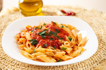 Penne pasta with tomato sauce. Traditional Italian dish, pasta with chili sauce. Italian food.