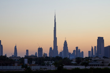 Fototapeta na wymiar Dubai skyline with Burj Khalifa skyscraper at sunset, clear sky in United Arab Emirates