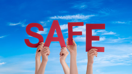 People Hands Holding Colorful English Word Safe. Blue Sky As Background