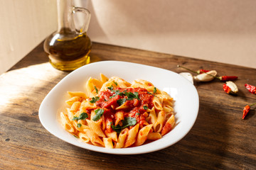 Penne pasta with tomato sauce. Traditional Italian dish, pasta with chili sauce. Italian food.