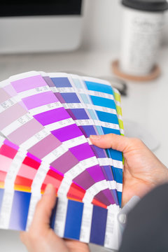 Graphic designer works on the choice of palette colors for creative business