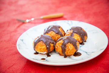 Profiterole with vanilla and chocolate sauce